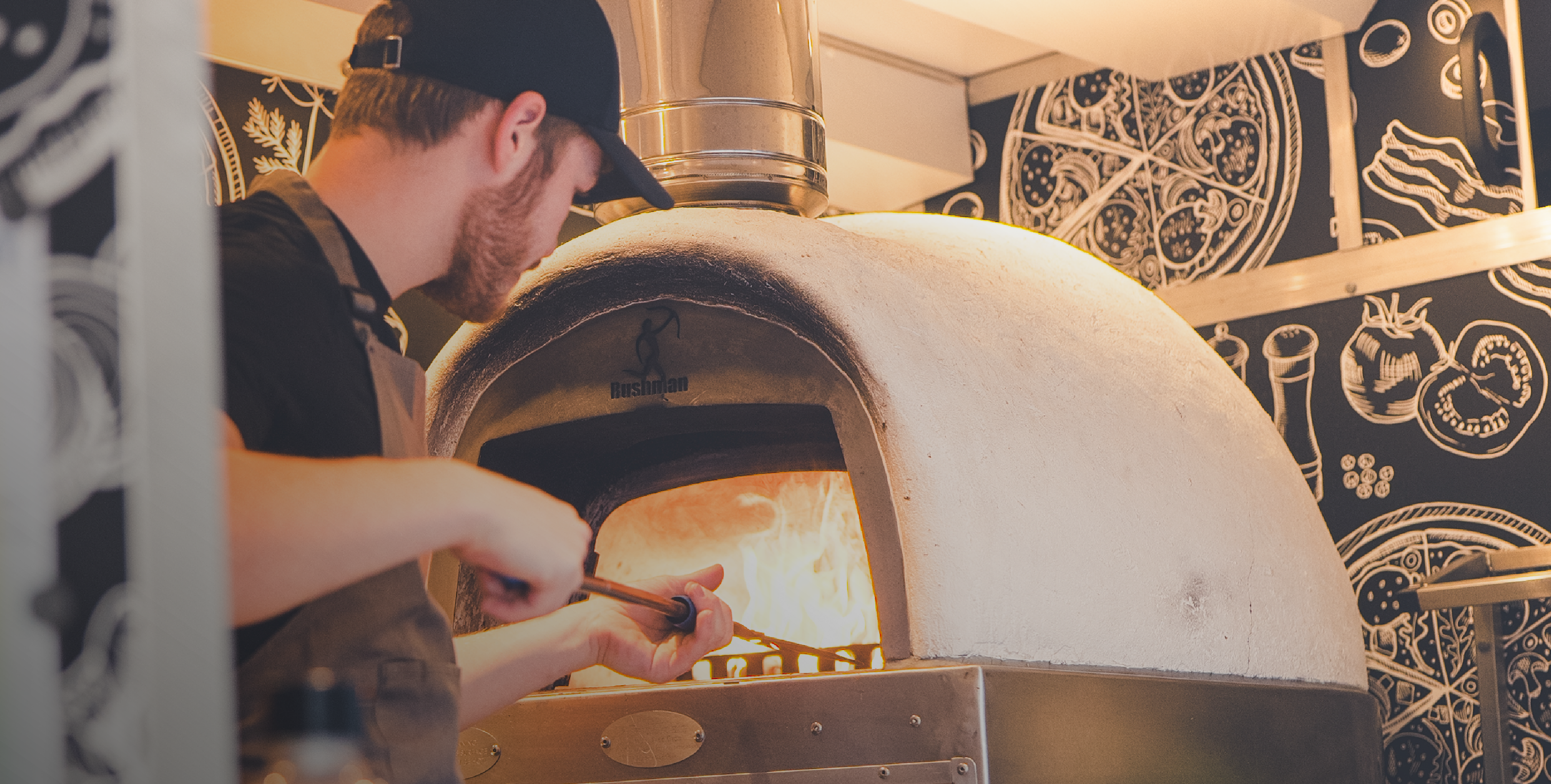 Wood fired pizza oven glowing with flame